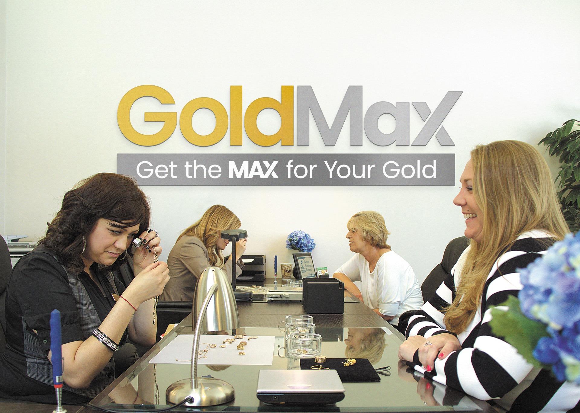 GoldMax team evaluating jewelry with a customer